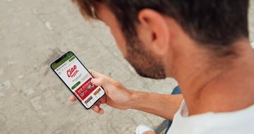 man holding smartphone with Ciao Rewards app being shown