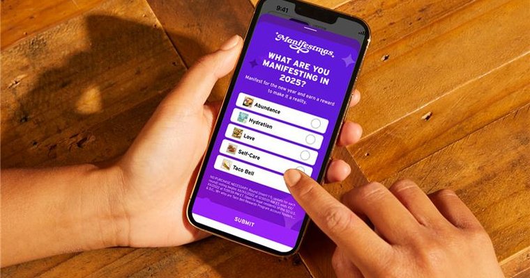 Person holding smartphone with Taco Bell promotion.