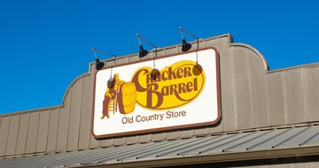 Exterior front exterior facade sign logo for restaurant chain Cracker Barrel Old Country and gift store.