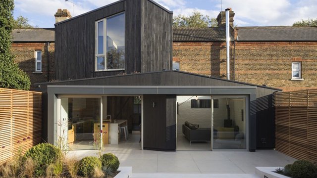 Charred timber cladding, green roof connect Victorian-era home to nature